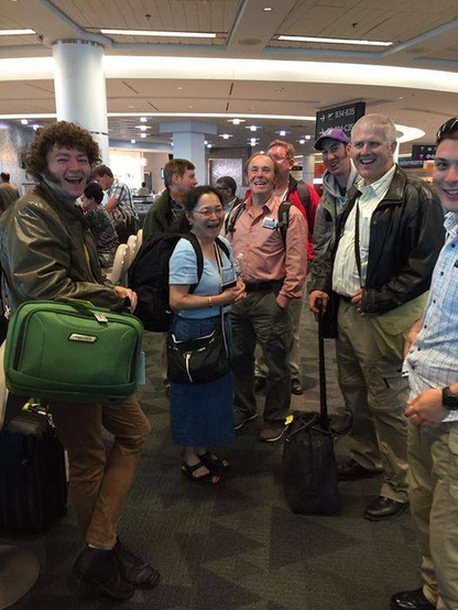 Group of happy travelers at the airport