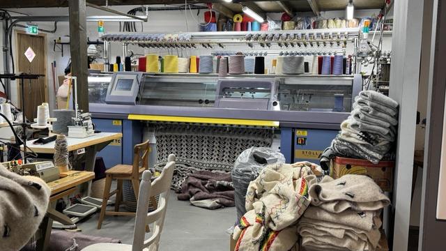 A Stoll contemporary industrial electronic v-bed knitting machine, currently knitting yardage of double-bed jacquard with an all-over puffin pattern. This was in the Kayla Wool Shop in Vik. They had two other v-beds as well — one of which was a delightfully chunky 3 gauge — and a circular machine very similar to the previous picture. 
