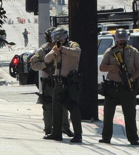 Police aiming a gun at the person taking the photo.