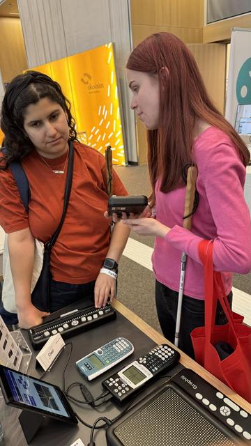A visitor having their hand on experience with different Orbit devices.