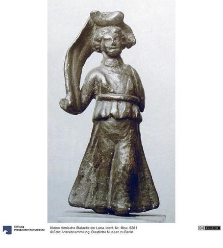 Bronze statuette of Luna. She is dressed in a peplos, wearing her iconic lunar crescent on her head and the cloak billowing behind it.
