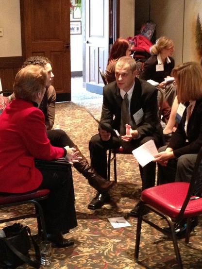 How do you facilitate change: photograph of a small group of people sitting in a circle of chairs