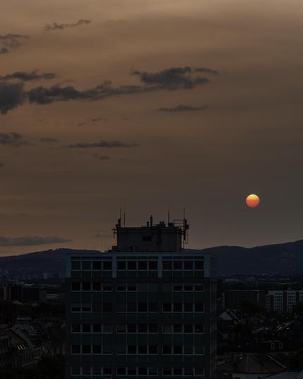 Sunset over parts of Frankfurt city centre, with the sun looking more like a blood moon due to smoke from Canadian forest fires having blown over the Atlantic.