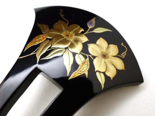 Gold Clematis flowers on black lacquer hair piece.