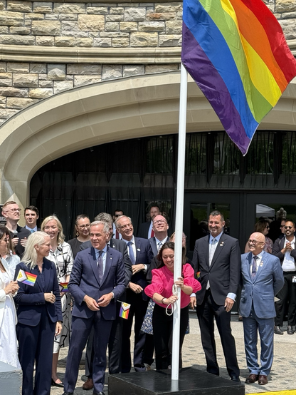PM Mark Carney raising Pride flag. 