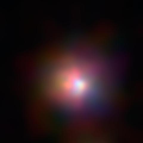 A blurry, abstract image with blobs of white, pink, blue and yellow colors. The brightest area is a white blob to the lower right.