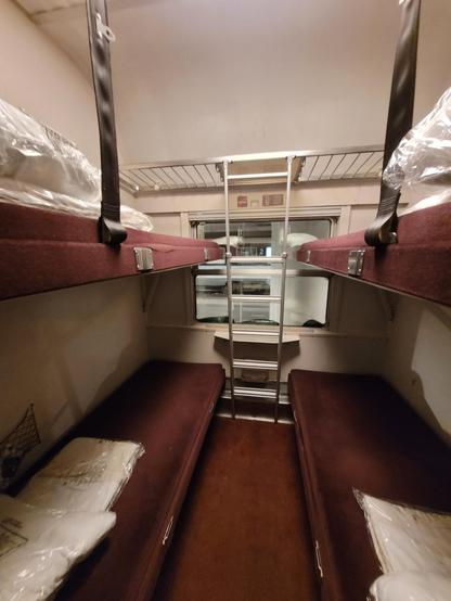 4-couchette compartment, two bunk beds on each side, with an older-looking red/brown carpet finish.