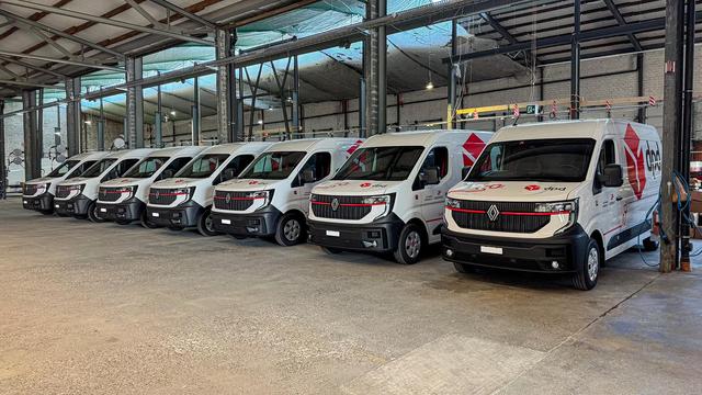 Fleet of DPD Renault electric vans parked inside a building