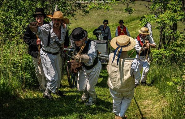 Naval landing party struggling to move their gun up a slope