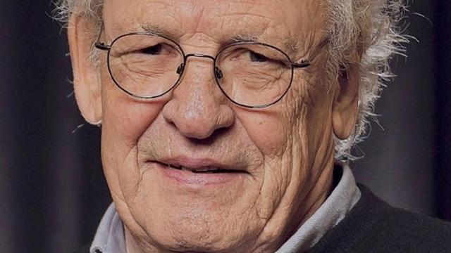 Porträtfoto von Robert Boner, einem älteren Herrn mit Brille,in die Kamera lächelnd.