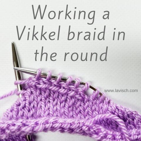 A knitting project worked in the round in lilac yarn on a circular needle, Vikkel braid is being worked.
