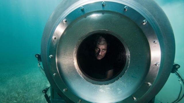 OceanGate CEO Stockton Rush peering through sub viewport