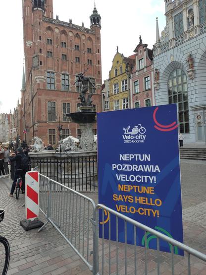 a sculpture of Neptune and a sign: Neptune says hello to velo-city