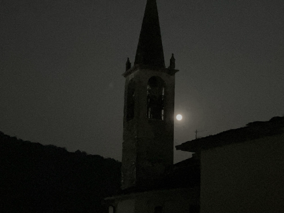Romagnano church tower in front of a full moon