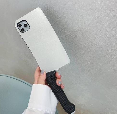 Hand holding an iPhone in a case shaped like a butcher knife with a handle. 