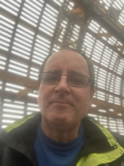 Selfie of the poster standing inside the airship with wooden lattice work in the background