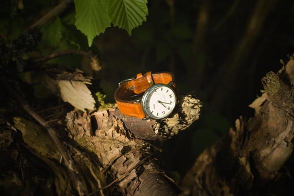 Photo shows a light brown watch strap attached to the watch it is made for. Strap has a classic cut and look. 