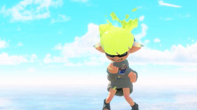 A screenshot of Splatoon 3 on the Nintendo Switch 2. The image is of an Inkling with neon yellow ink doing a fist pump (pumping the fist down towards itself, not up in the air) while having an excited expression (closed-eyes smile). The Inkling is wearing the Hero Mindset Replica, the Manatee Swag Sweat, and the Kick Dampeners. The overall stance of the Inkling is pigeon toed and is in front of a cloudy but still sunny blue sky. The Inkling's hair is doing the effects for when the special charge meter is full.