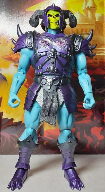A photo of the action figure Battle Armor Skeletor from Mattel's New Eternia line. This version of Skeletor still has the blue skin and yellow skull face but also has elaborate torso armour and a horned helmet. This armour is purple and black and features a battle damaged central plate on the chest. Here, Skeletor is standing straight a looking down his nose (if he had one) at the camera.