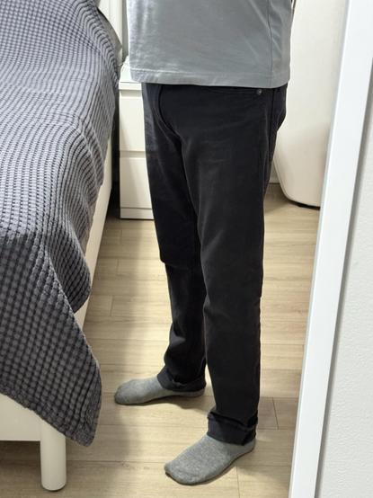 Mirror selfie of me wearing size 30 × 30 men’s ready-to-wear pants with the hems rolled up just over two inches.