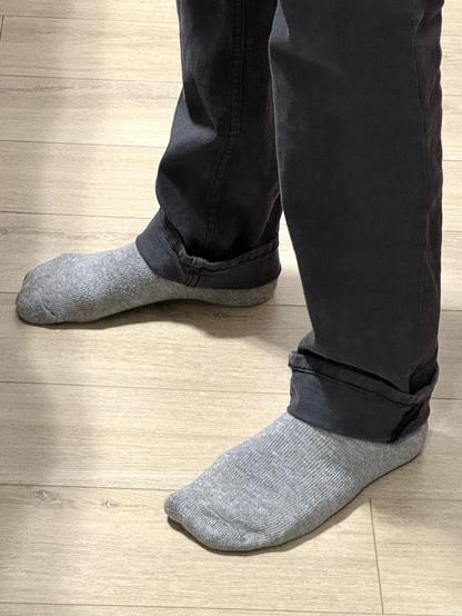 Closeup mirror selfie of me wearing size 30 × 30 men’s ready-to-wear pants with the hems rolled up just over two inches.
