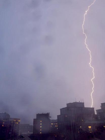 A view of the Courthouse neighborhood of Arlington VA through a rain covered window. There is a distinct lightning bolt on the right side of the image