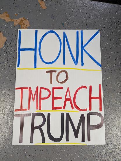 Protest sign that reads HONK TO IMPEACH TRUMP.