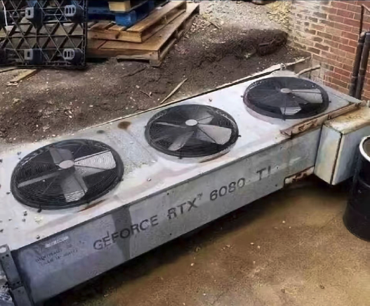 A photograph of an air conditioner that someone has stencilled on "GFORCE RTX 6080 TI" as a snarky comment about the growing power consumption and heat output of each successive generation of this product. (Not my work, found online)