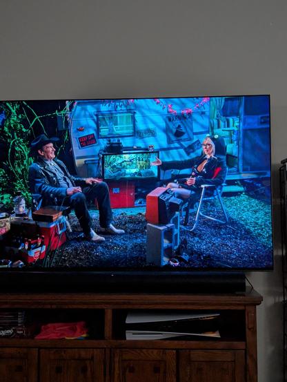 A TV with The Last Drive-in on it. It's a wide shot of Joe Bob and Darcy talking.
