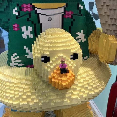 Little Caz sigfig perched on the nose of a huge ducky rubber ring around the waist of a massive brick built Minifigure. 
