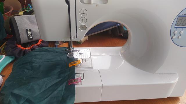 My sewing machine with some green nylon being sewn. 