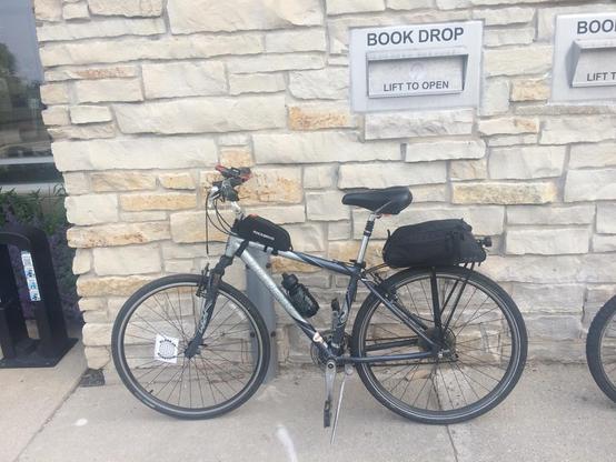 A bike at a library drop box.