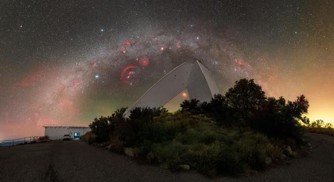 This Image of the Week contrasts the beautiful curve of the Milky Way with the geometric architecture of NSF's recently retired McMath-Pierce Solar Telescope at the U.S. National Science Foundation Kitt Peak National Observatory (KPNO), a Program of NSF NOIRLab, near Tucson, Arizona. The McMath-Pierce Solar Telescope was once the largest solar telescope in the world, standing 33 meters (110 feet) tall with a 60-meter (200-foot) long diagonal shaft that continues underground. As a reflecting telescope, this instrument relied on mirrors to see the skies, and its diagonal bend led towards its 1.6-meter-diameter primary mirror.