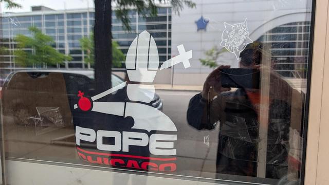 Photo of a dark blue shirt with Harebrained's Pope White Sox logo on the shirt, with the Chicago PD logo on the sleeve