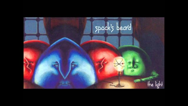 Combined front and back cover image from Spock's Beard debut album, "The Light".
Three spheres with facial features in blue, red and green sit at a brown table on which sits a lamp illuminating them. Behinf them is a paned window with brown curtains. The back cover on the left is mirrored in the center, dividing the blue face and showing most of the red.
