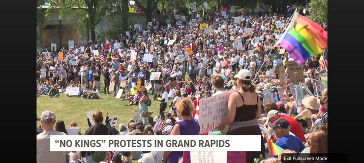 Freeze frame capture from a local ABC affiliate TV station's news report, showing the June 14th No Kings protest, showing thousands of people with banners, flags, and signs prior to their protest march.