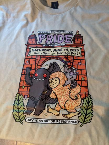 Shirt that my partner bought me from our friends stand, @ShapelessFlame. Image is of Mothman & Sasquatch arm n' arm with a little raccoon holding a pride flag. Text reads Friendlier City Project Presents Pride on the Plaza. Saturday, June 15, 2025. 3pm-9pm Heritage Port. Joy Is An Act Of Resistance.
Please check out her other art, it's wonderful! https://www.shapelessflame.com/shop