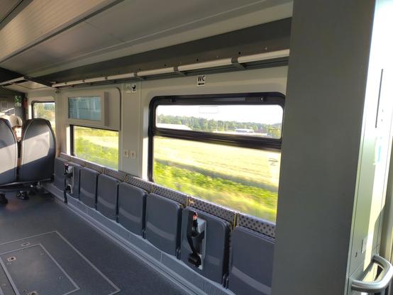The interior of a train showing bicycle places with folding seats