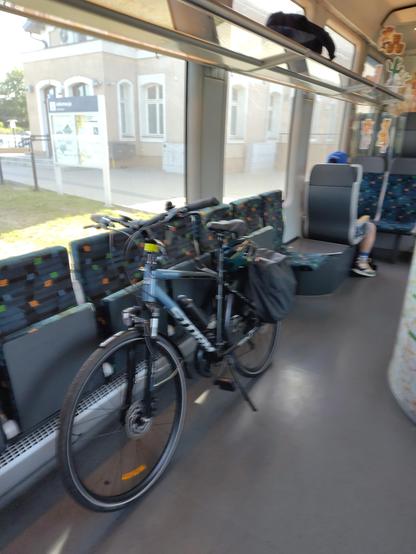 Bike leaning against folded seats on a train