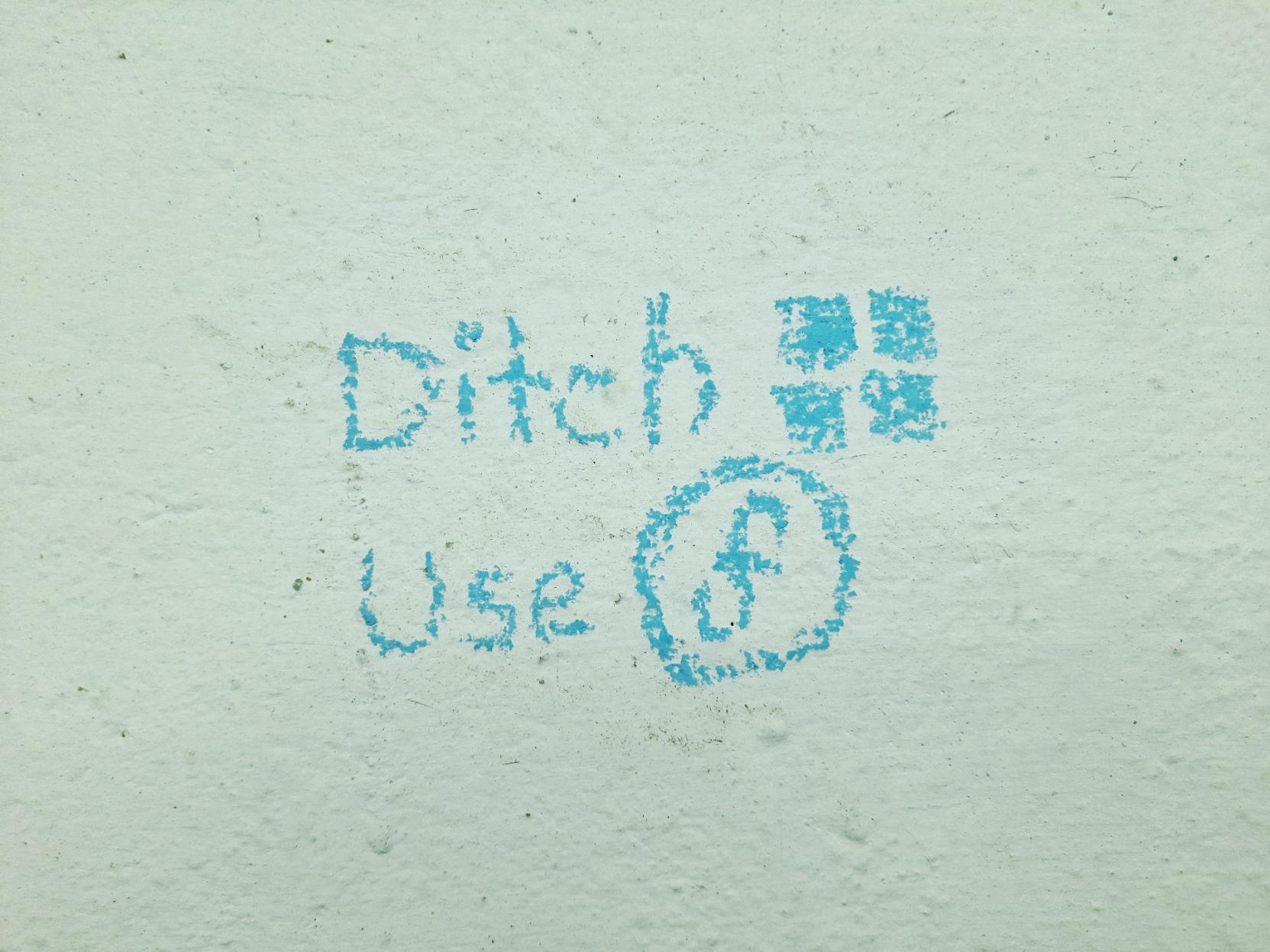 A white wall inside a classroom of a college, on which "Ditch Windows, Use Fedora" is written using a blue chalk. The words "Windows" and "Fedora" are implied with their respective hand-drawn logos. A white wall inside a classroom of a college, on which "Ditch Windows, Use Fedora" is written using a blue chalk. The words "Windows" and "Fedora" are implied with their respective hand-drawn logos.