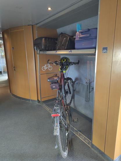 Bicycle storage on a train for two bikes. One bike is attached.