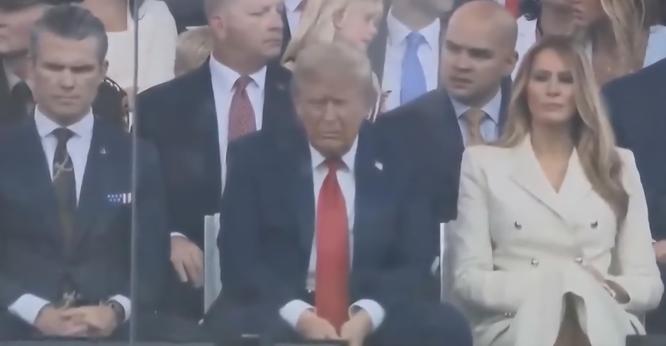 Donald Trump with a sad/bored expression sitting left to Melanie Trump and right to Pete Hegseth during his "Birthday Parade" ...