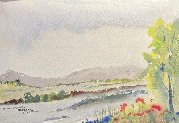 This is a watercolor of an open field. There ar mountains in the background, followed by a row of trees. A tall tree grows on the right, and a river flows behind it, lined with vegetation. Flowers grow in the lower right corner. 