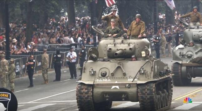Sparse crowd as tanks roll down the streets of DC.