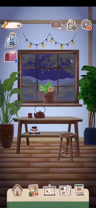 A screenshot from the app A Kinder World showing a cartoon room with table and stool, a sand art and tea kettle and cup are on the table. 
Above the table is a window with an adorable plant growing on the window, the plants pot has a face that looks content. The plant has rare leaves shaped like hearts that are sometimes green and sometimes red and peach colored. This room is personalized by me with larger green plants on either side of the table and window with fairy lights hanging above. It shows as night time or day time according to the te on your phone. I love this little app and highly recommend!