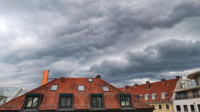 Thunderstorm clouds over roofs