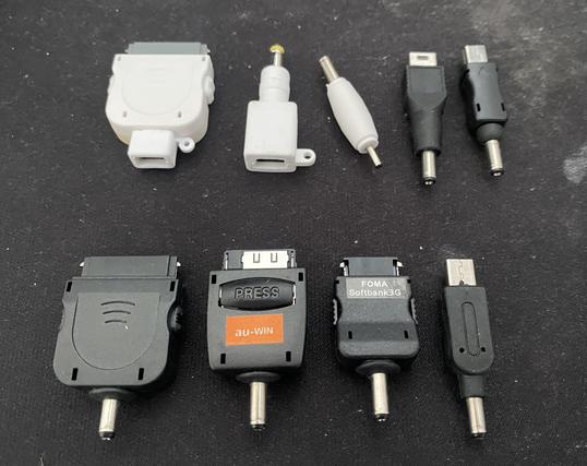 Various phone charger adapters on a black mouse pad 