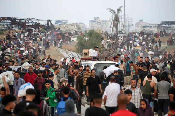 People carry relief supplies from the Gaza Humanitarian Foundation in the central Gaza Strip [File: Eyad Baba/AFP]