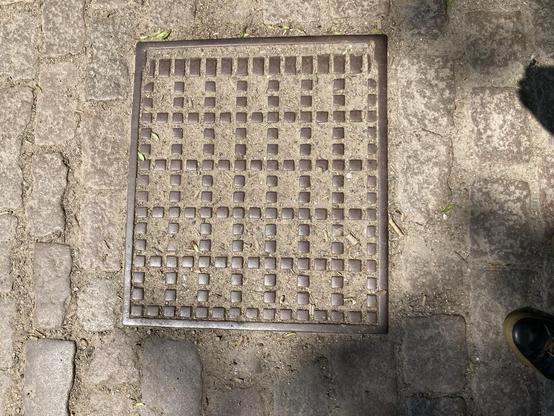 A pretty rectangular cover with a grid-like pattern of rectangular squares 