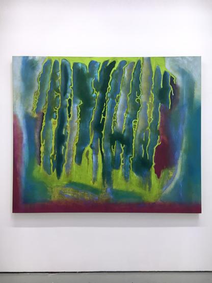 Abstract painting featuring vibrant colors displayed on a white wall, creating a striking visual contrast.
